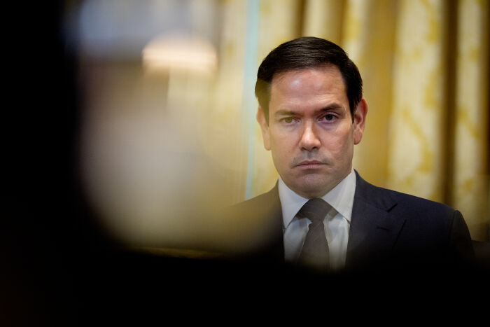 Man in a suit with serious expression in a formal room, symbolizing altered U.S. human rights report priorities.