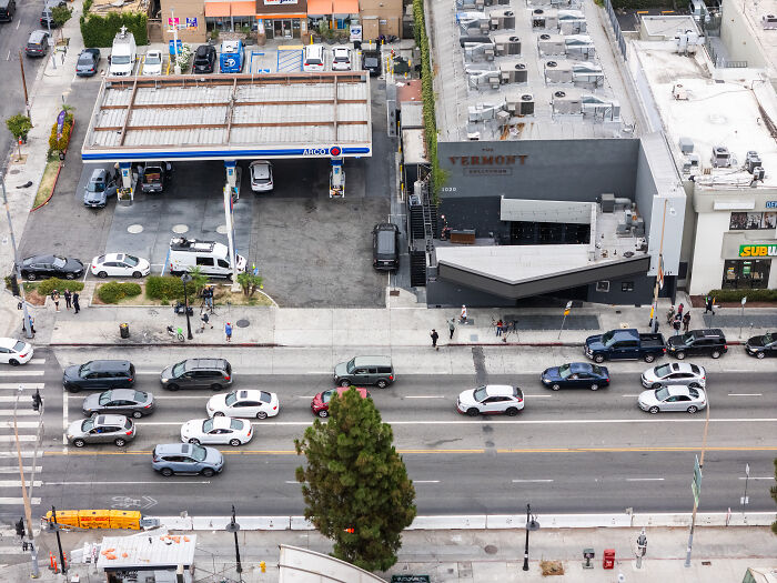 Aerial view of street and crowd outside L.A. club after police arrest man accused of shooting driver incident.