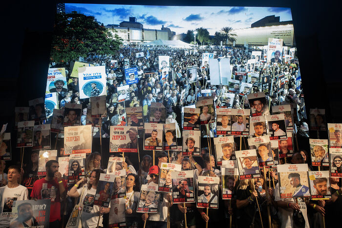 Thousands of Israelis holding posters during a large protest demanding an end to the war in Gaza and release of hostages.
