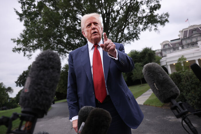 Man in a suit speaking to multiple microphones outdoors amid concerns over press freedom and journalist safety in Israel.