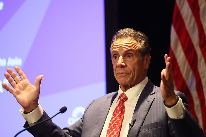 Eric Adams speaking at podium with American flag behind, addressing NYC mayoral hopeful Zohran Mamdani and adult work decriminalization.