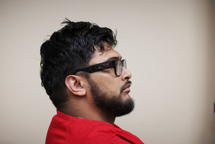 Man with beard and glasses wearing a red shirt in profile, related to Emmanuel Haro&rsquo;s dad confessed case report.
