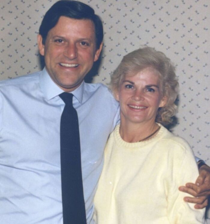 Couple smiling together indoors, representing Erik Menendez denied parole related to parents slaying case.