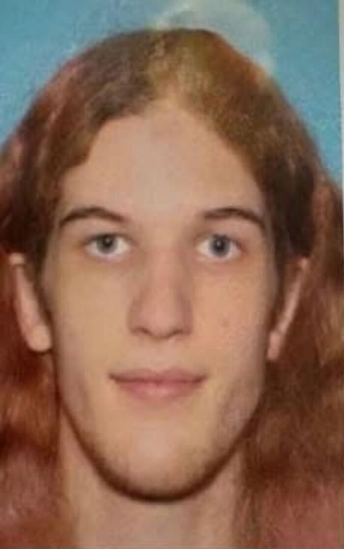 Close-up of young person with long hair, related to Minneapolis school tragedy report, highlighting trans people firearm ban concerns.