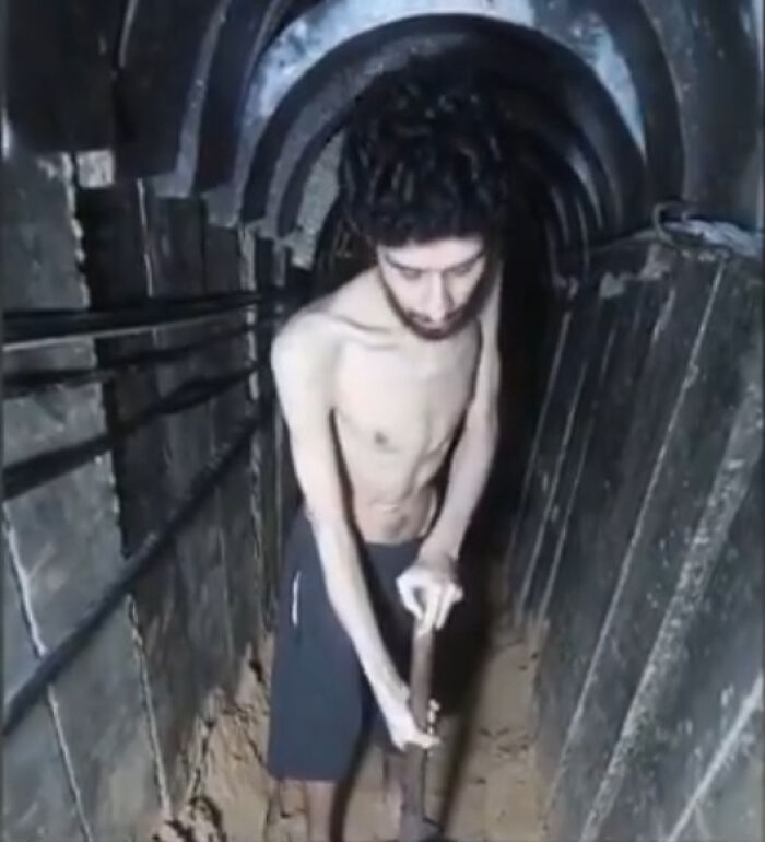 Emaciated man in a tunnel, highlighting starving hostages amid demands to end war in Gaza by thousands of Israelis.