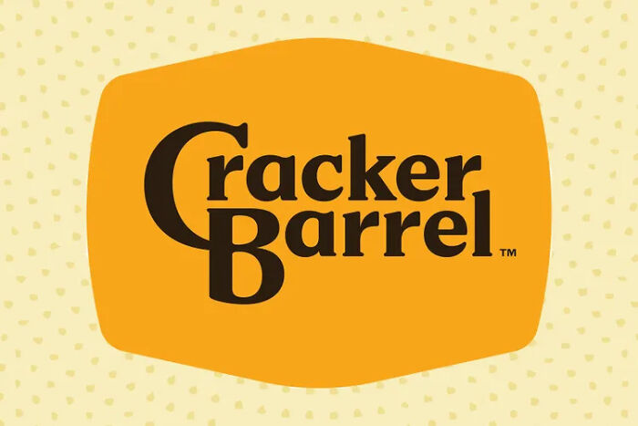 Cracker Barrel logo displayed on an orange background representing the brand amid recent logo controversy and fan outrage.