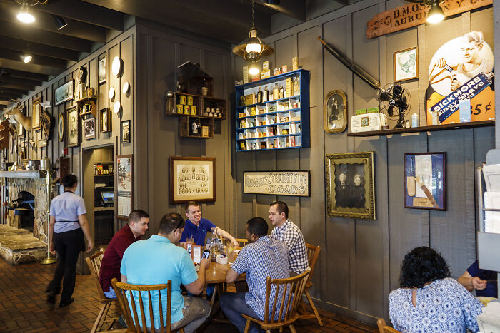 Customers dining inside a rustic Cracker Barrel restaurant, showcasing vintage decor and a cozy atmosphere.