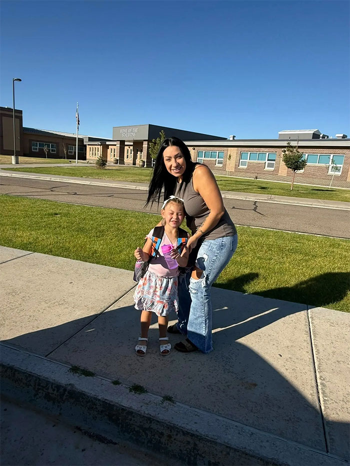 Mother and young daughter smiling outside a school building in Utah, related to botched delivery and hospital case.