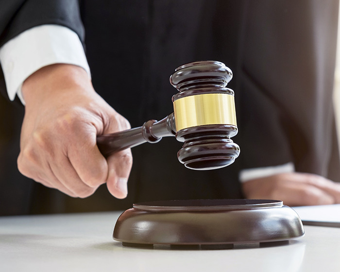 Judge holding a gavel ready to strike, symbolizing sentencing in a case involving mom who drained son&rsquo;s blood.