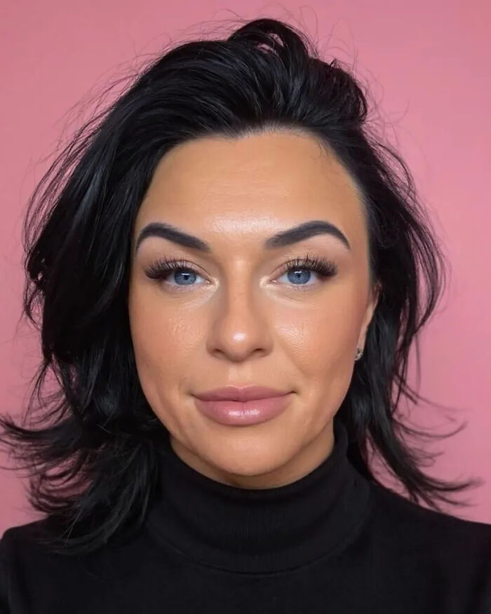 Close-up portrait of a woman with dark hair and blue eyes against a pink background, related to Alabama priest scandal.