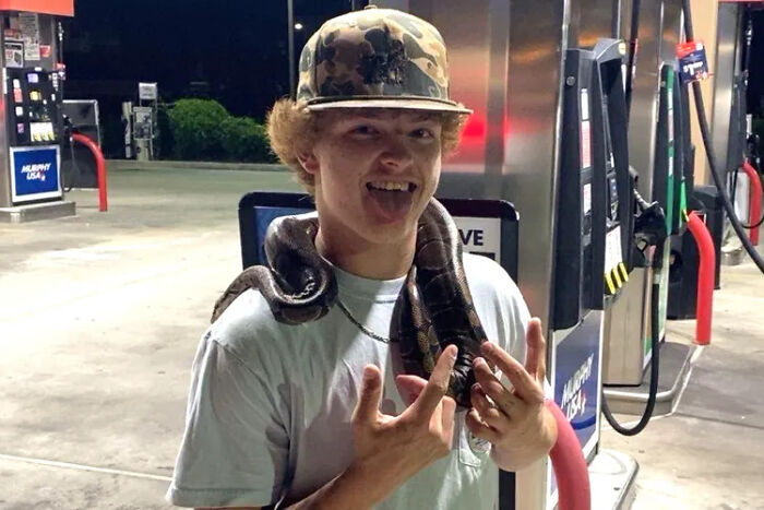 Teen at gas station with snake around his neck, related to slain teen and queen bee cheerleader girlfriend case.