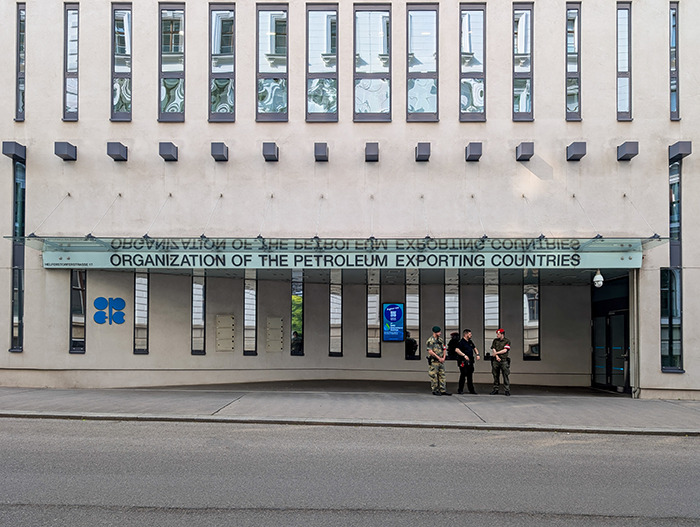 Exterior of the Organization of the Petroleum Exporting Countries building with three armed guards, illustrating Brics dollar and shifting global order.