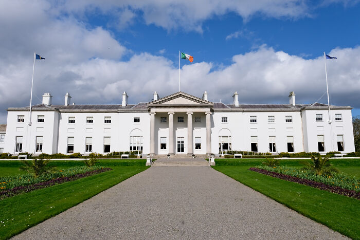 Ireland presidential residence with Irish flag flying, symbolizing Conor McGregor pulling out of Ireland presidency race.