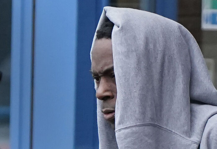A man wearing a gray hoodie walking outside with a serious expression, related to Aristocrat Constance Marten case.