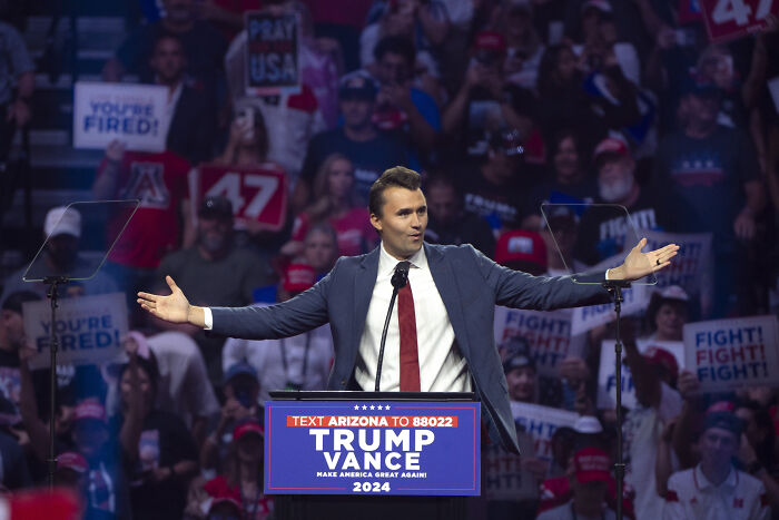Charlie Kirk speaking at a Trump Vance rally, addressing firearm fatalities and their perceived worth to supporters.