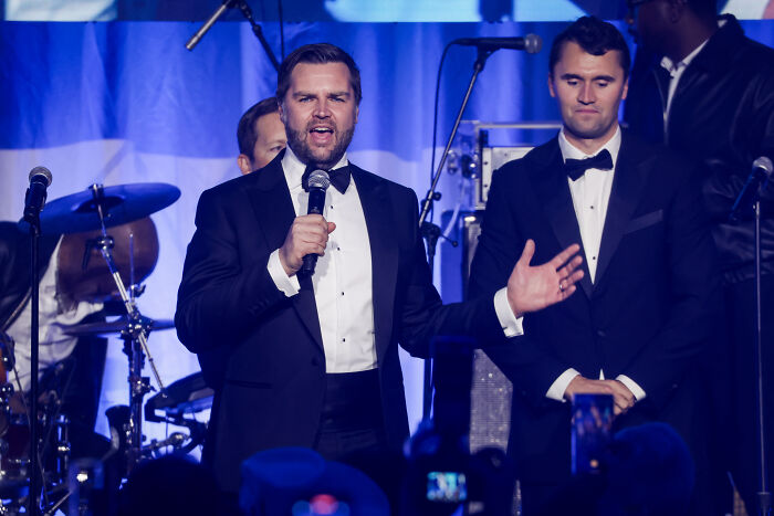 Charlie Kirk speaking into a microphone at an event, discussing firearm fatalities as the clip goes viral.