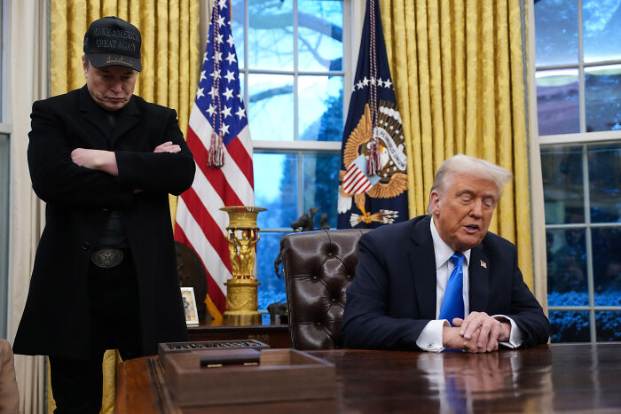 Donald Trump and Elon Musk in the Oval Office, captured during their reunion, engaged in conversation.