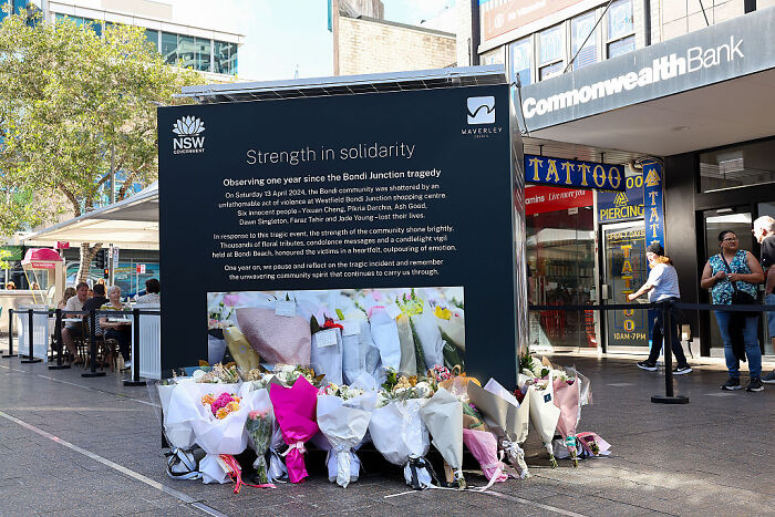 Memorial site with flowers and signboard honoring victims, illustrating social media's impact on Donald Trump narrative.