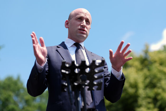 Stephen Miller speaking outdoors in a suit and tie, addressing plans to target left-wing terror movement.