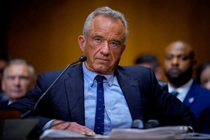 Man in suit and tie at a hearing, representing a topic related to sacked CDC director resisting vaccine plans.