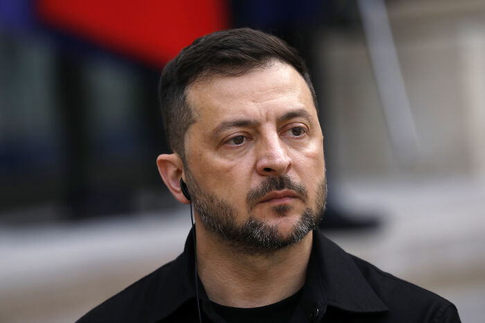 Close-up of a serious man wearing black, representing tensions after Poland shot down Russian drones deep in its territory.