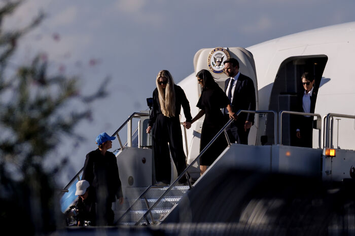 VP JD Vance boarding Air Force Two with others in a somber setting transporting Charlie Kirk&rsquo;s casket home
