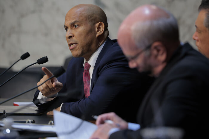 Kash Patel in a heated discussion with Adam Schiff over Epstein files during a formal congressional hearing session.