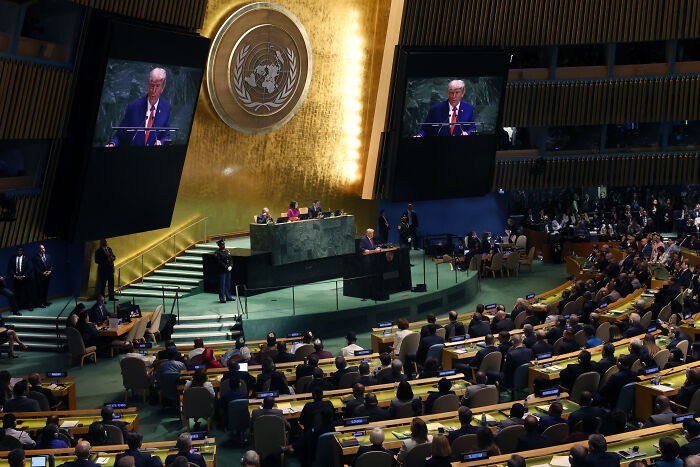 Donald Trump speaking at the UN General Assembly, addressing immigration and Europe in front of a large audience.