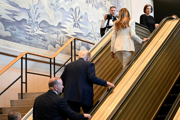 Donald Trump riding an escalator at the United Nations after escalator and teleprompter issues during speech preparation.
