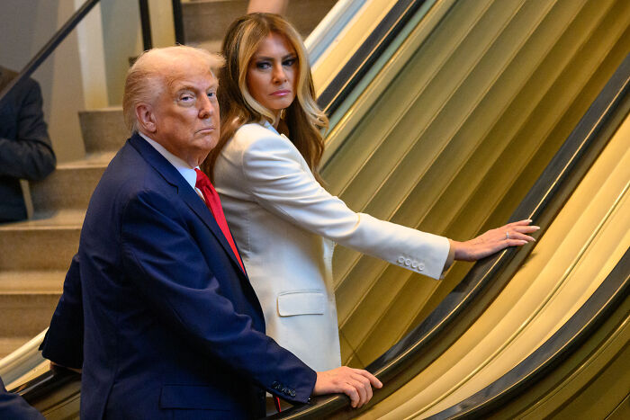 Donald Trump and Melania Trump on an escalator, linked to White House claims of a UN staff plan to embarrass them.