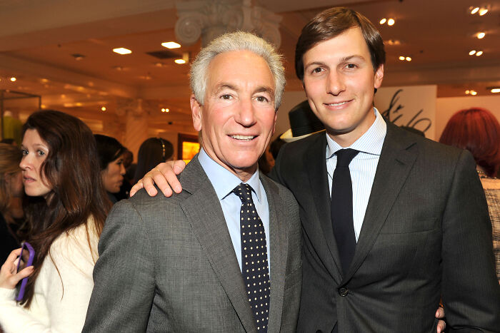 Two men in suits posing and smiling at a formal event related to Trump commuting sentence of family-connected criminal.