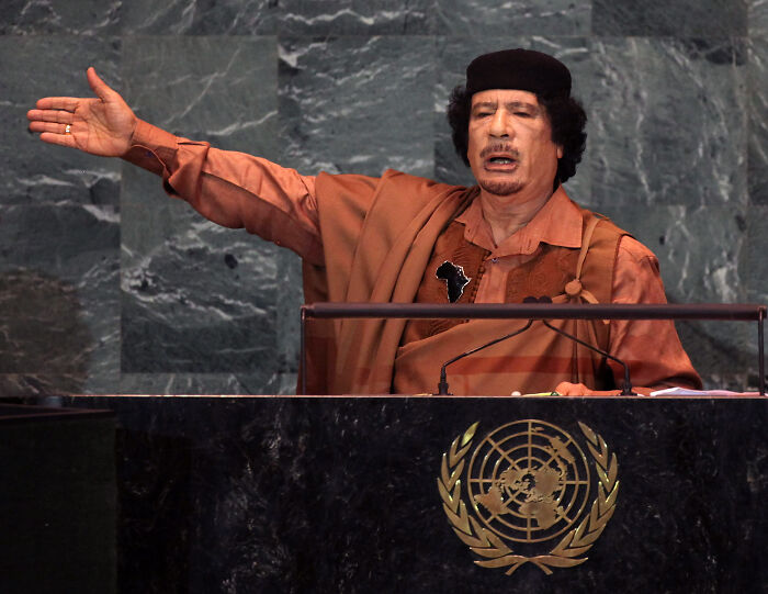 Man in traditional attire speaking passionately at a United Nations podium, not related to former French President Nicolas Sarkozy.