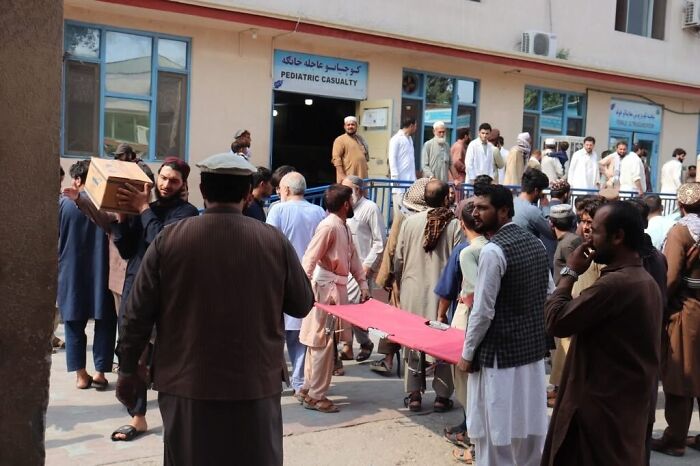 Rescue teams and locals outside a pediatric casualty unit in Afghanistan after earthquake disaster relief efforts begin.