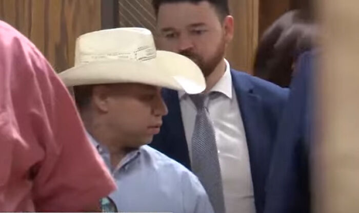 Man in a cowboy hat and man in a suit in a courtroom setting related to dad guilty of manslaughter case