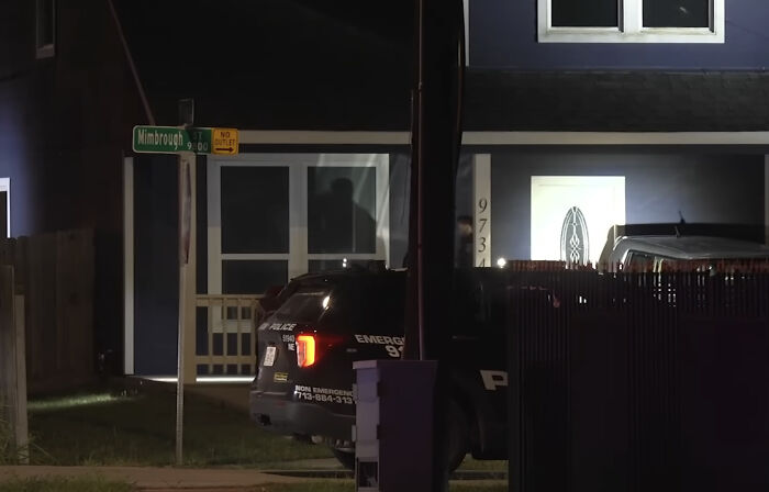 Police vehicle parked outside a Houston home at night after an 11-year-old boy was fatally shot playing doorbell prank.