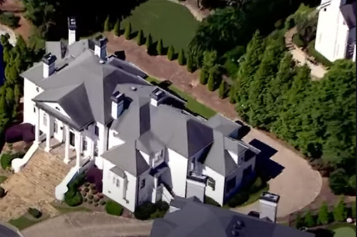 Aerial view of a $1.7M mansion surrounded by trees and landscaping linked to dentist&rsquo;s rampage incident.