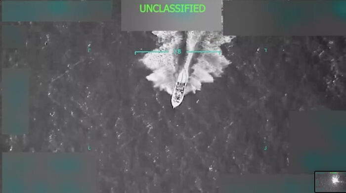 Military ship captured from above in ocean waters, related to Trump starting a war with Venezuela discussion.