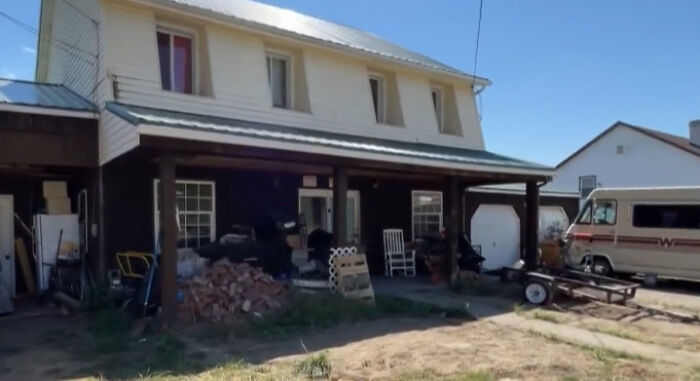 Exterior view of a rural house where a couple was arrested after children were found in a dungeon covered in human waste and fleas.