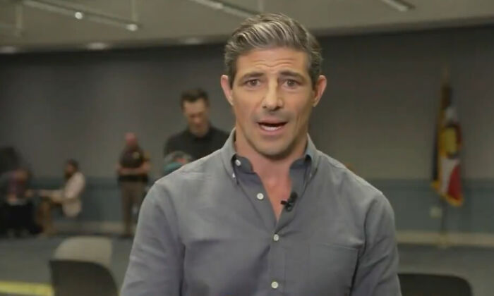 ABC News reporter in grey shirt speaking on camera with blurred background, related to Tyler Robinson texts controversy.