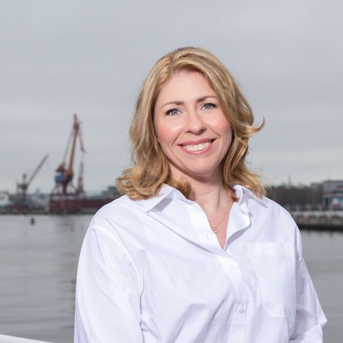 Sweden&rsquo;s new health minister smiling outdoors near a harbor on her first day at work before collapsing on live TV.