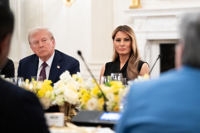 Former President Donald Trump and Melania Trump seated at a formal event, related to Melania Trump meme coin crypto fraud claims.