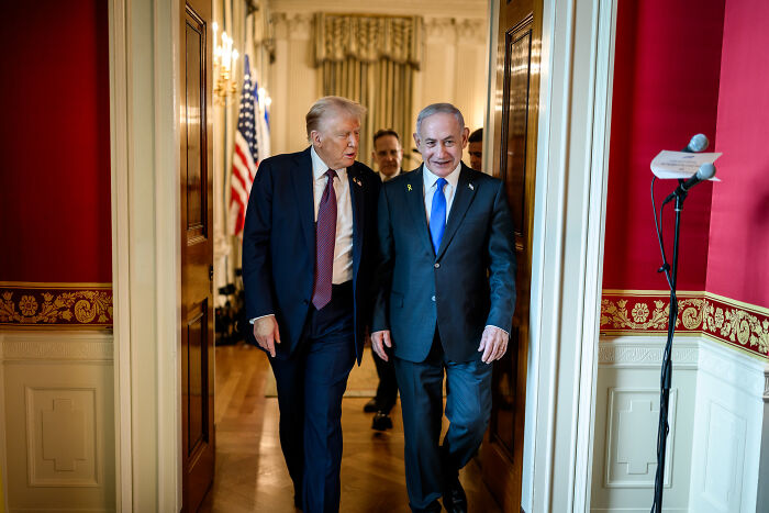 Donald Trump walking and talking with an official in a formal setting, related to Trump misses out on Nobel Peace Prize.