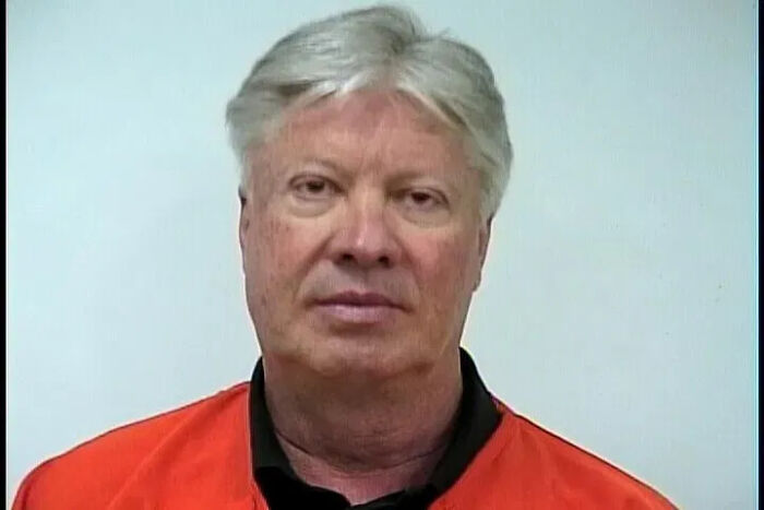 Man in an orange prison jumpsuit, representing Texas megachurch pastor Robert Morris involved in child sex abuse case.