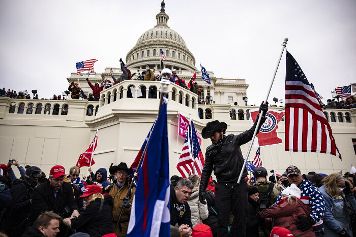 Crowd gathered outside the Capitol with flags and hats during the January 6 event, related to Trump called Pence wimp notes.