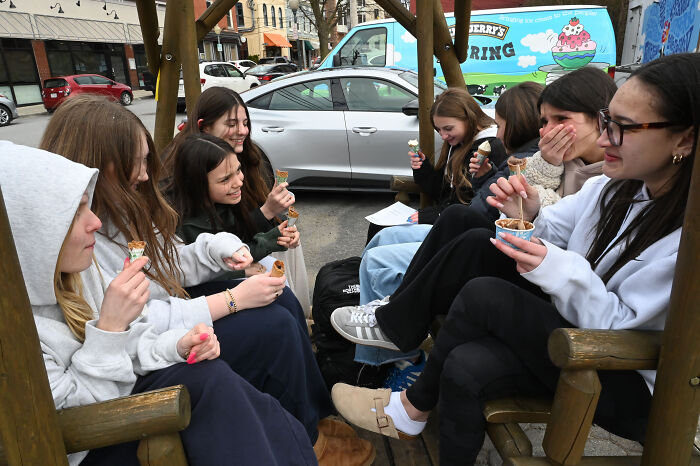 Group of young women enjoying ice cream together outdoors, capturing ChatGPT&rsquo;s her vibes and how to keep it real online.