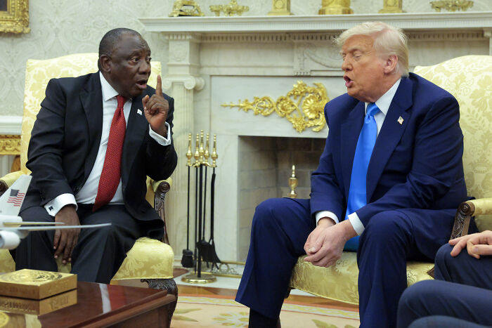 Donald Trump and South African leader in a formal meeting, discussing refugee cap and prioritizing white South Africans.
