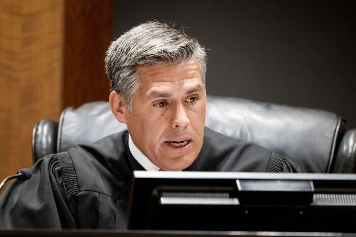 Judge in courtroom speaking during a hearing related to gag order and Charlie Kirk case involving Candace Owens.