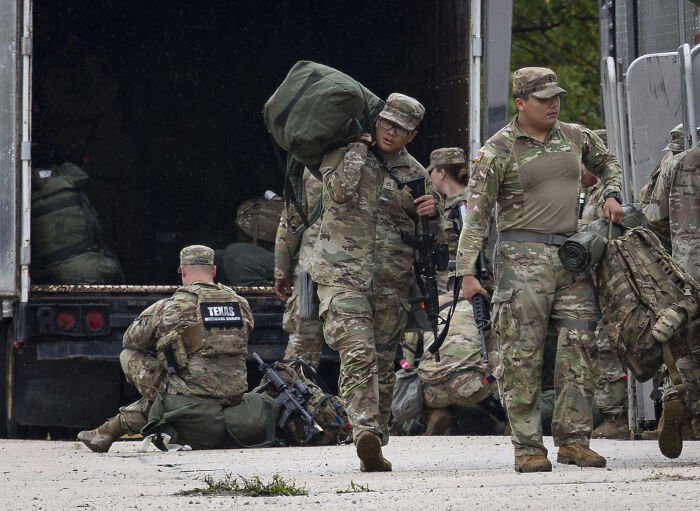 Soldiers arriving in Illinois unloading gear amid Pete Hegseth controversy over troop fitness and photos going viral.