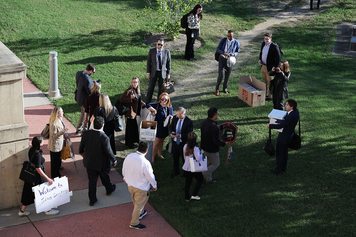 Reporters gathered outdoors staging a mass walkout in response to new Pentagon gag rules enforcement.