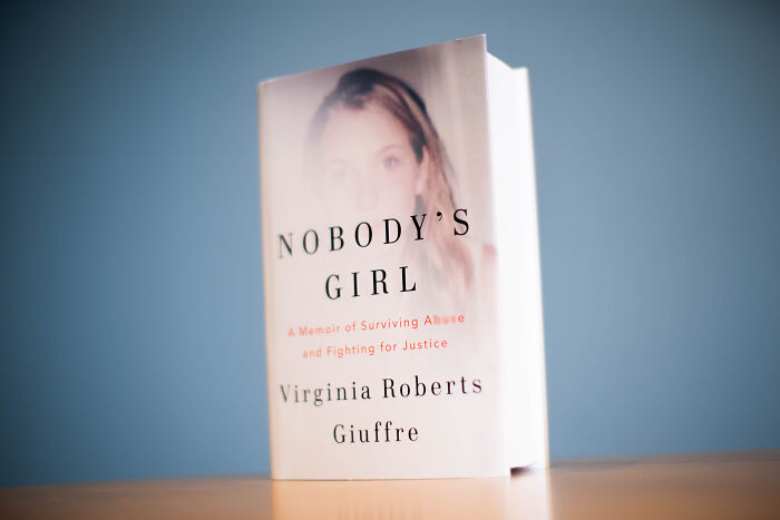 Book titled Nobody's Girl by Virginia Roberts Giuffre, memoir related to well-known prime minister assault allegations on a table.